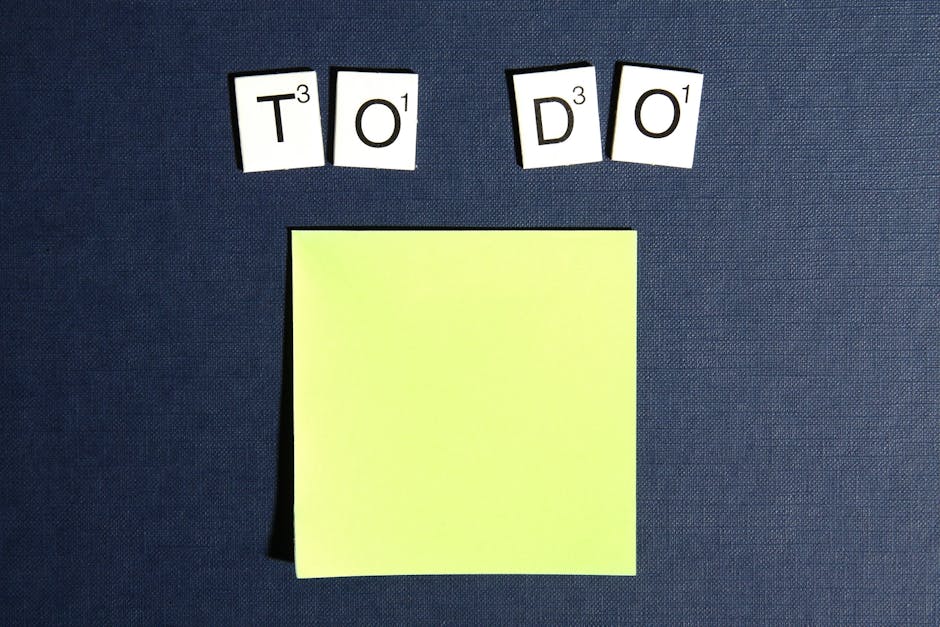 A blank sticky note displayed under scrabble tiles spelling 'To Do' on a blue background.